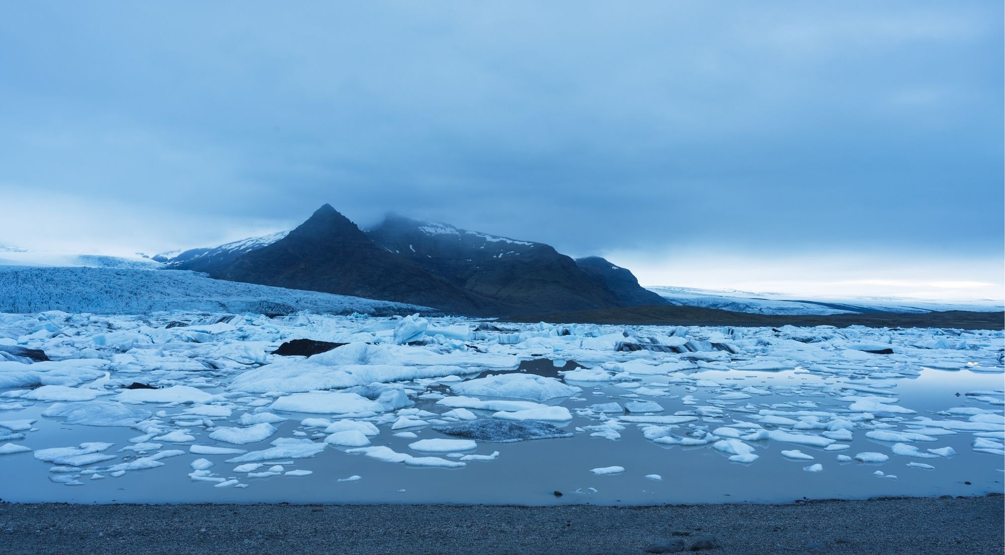 Broken ice on Fjallsárlón under a moody early-winter sky in November